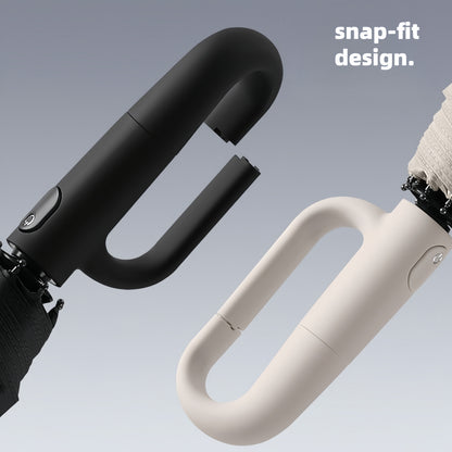 Ombrello pieghevole automatico con fibbia ad anello rotante, design elegante con rinforzo in fibra di vetro per resistenza al vento, in tessuto di alta qualità e con manico per una facile apertura con una sola mano. Il suo stile minimalista lo rende un re